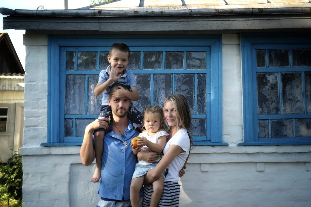The Davydenko family is standing in front of their new home. © Kseniia Tomchyk